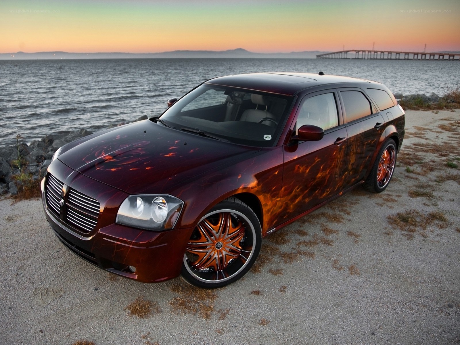 flame-painted car by the water