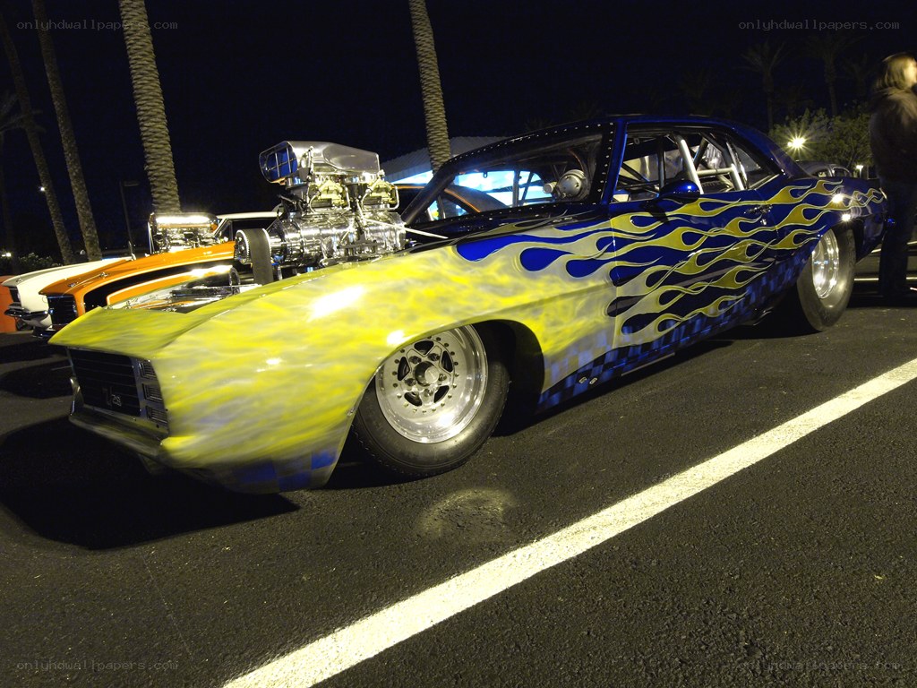 Flame-painted muscle car at night