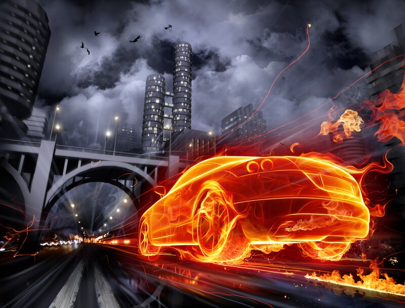 Flaming car in city at night