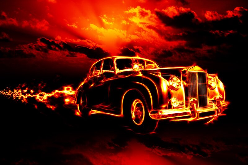 Flaming classic car at sunset