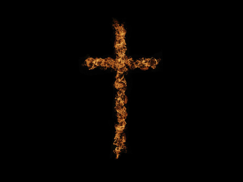 flaming cross on black background