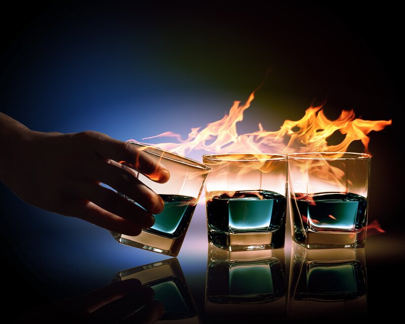 Flaming drinks on a dark table