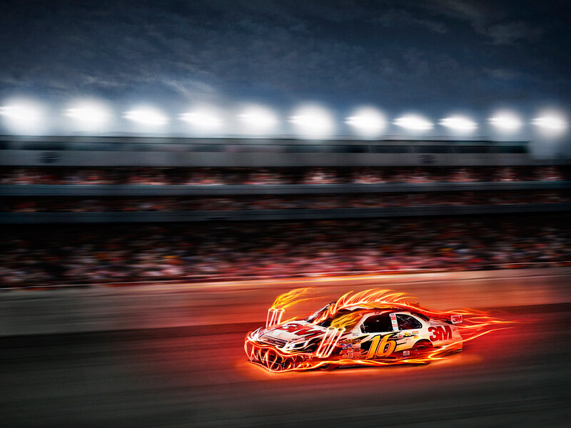 Flaming race car at night
