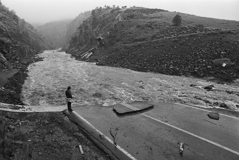 Flood-damaged road in mountain valley