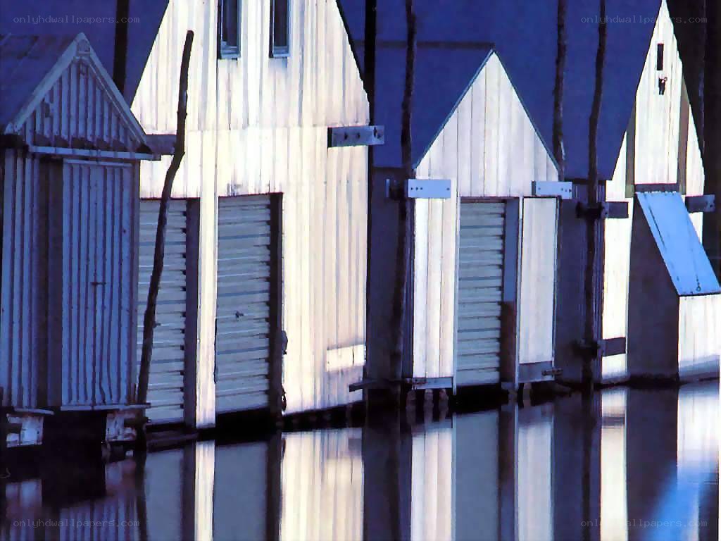 Flooded beach huts at dusk