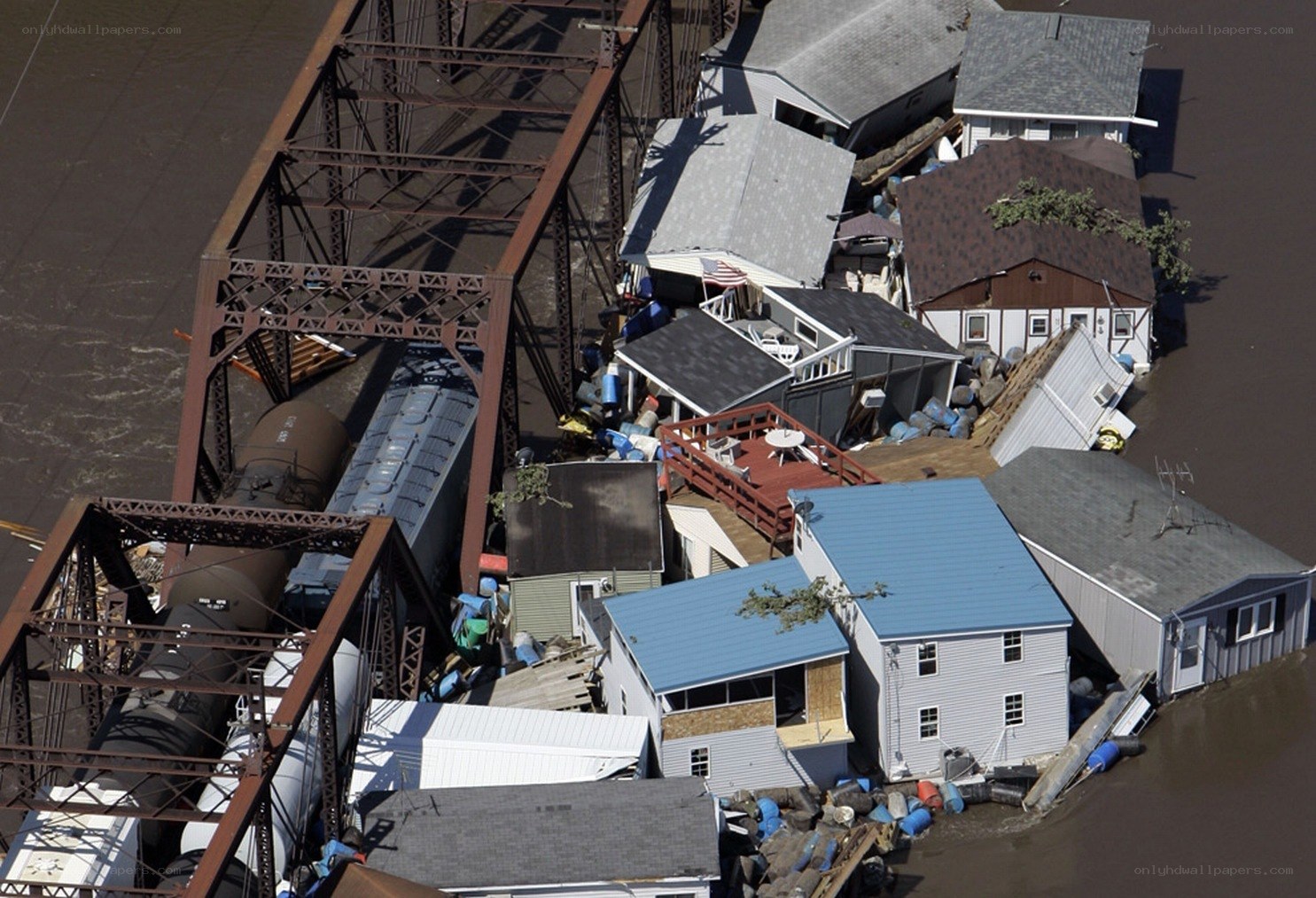 Flooded homes near train bridge