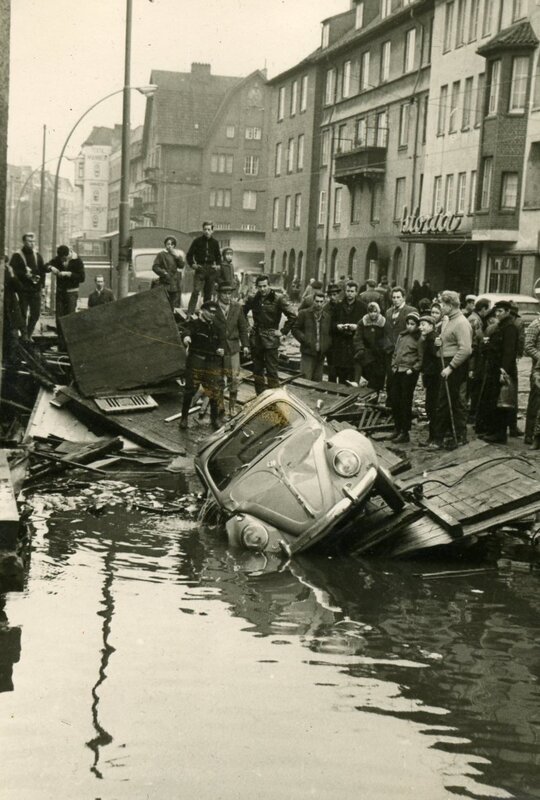 flooded street with damaged car