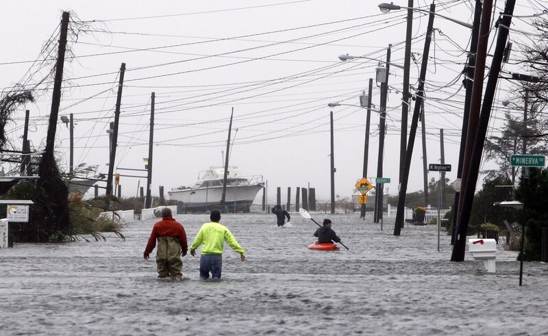 Flooded street with people and boat