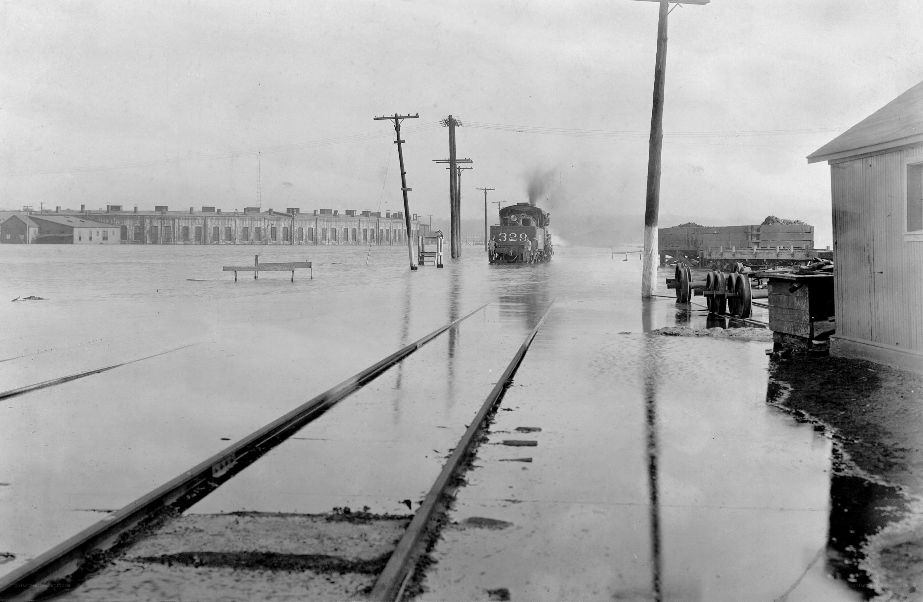 Flooded train yard with steam locomotive