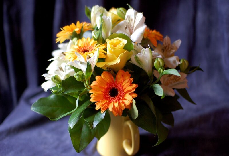 Floral arrangement in yellow vase