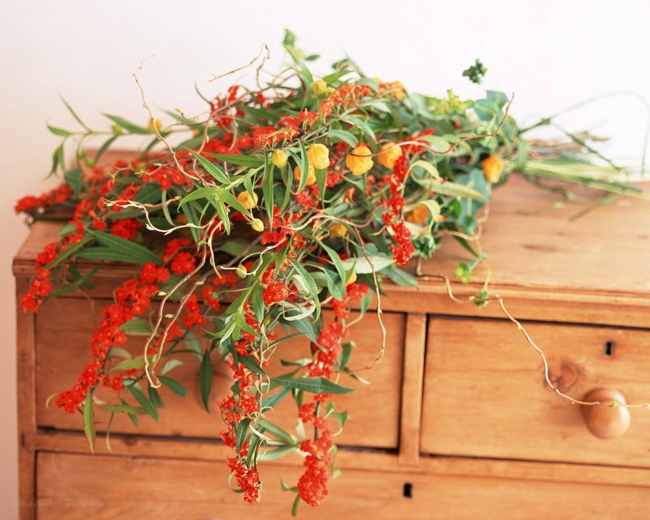 Floral arrangement on wooden chest