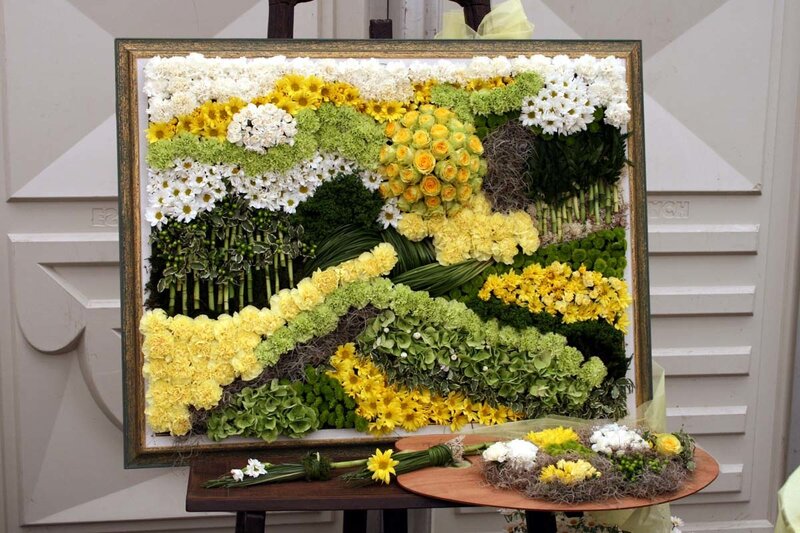 Floral art display with yellow and white flowers