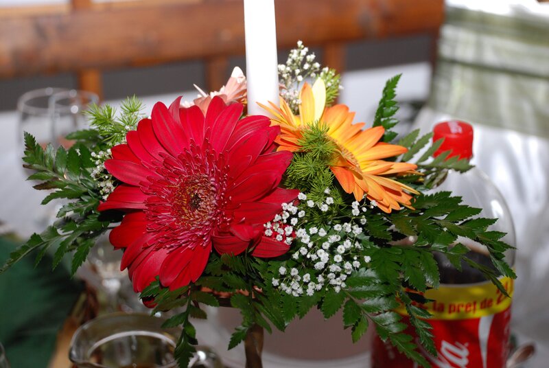 Floral centerpiece with red and orange flowers