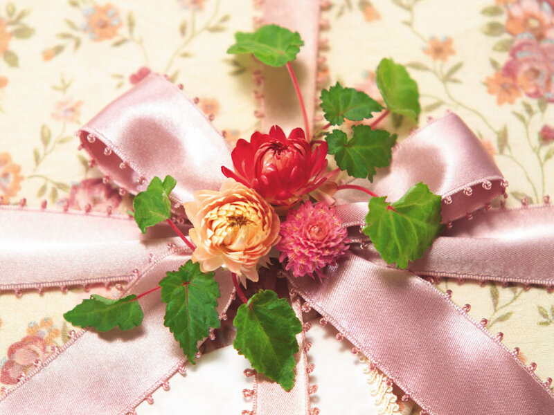 Floral gift with pink ribbon