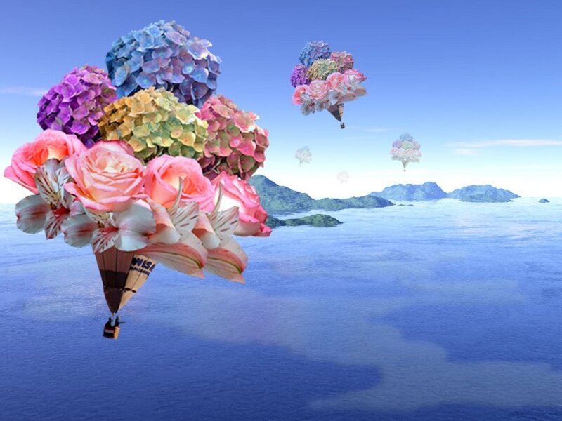 Floral hot air balloons over sea