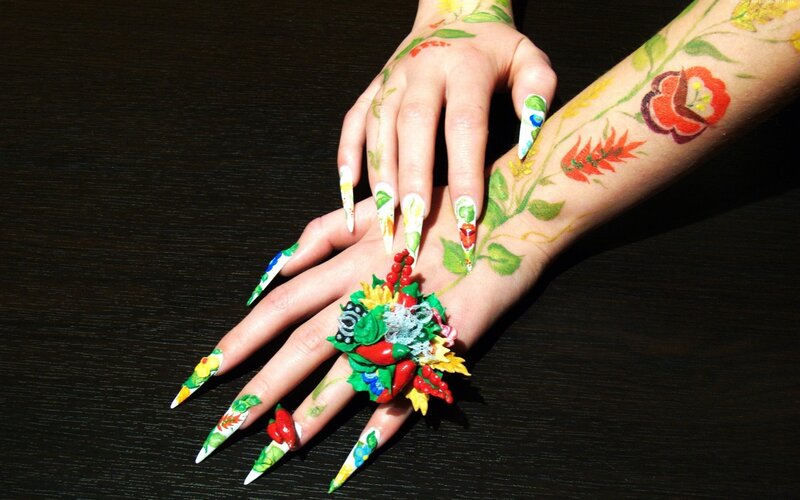 Floral nail art and arm tattoos