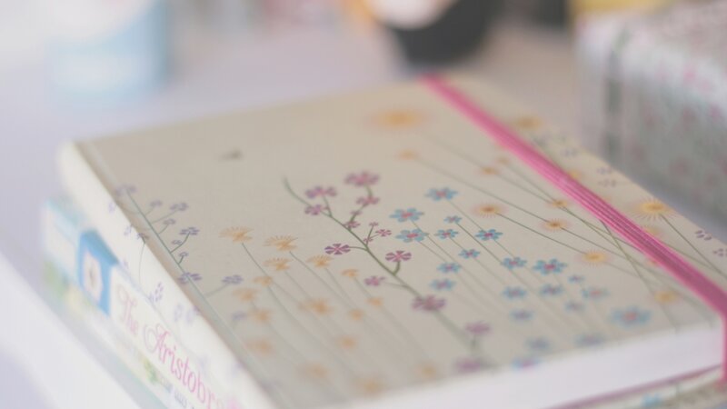 Floral notebook on stack
