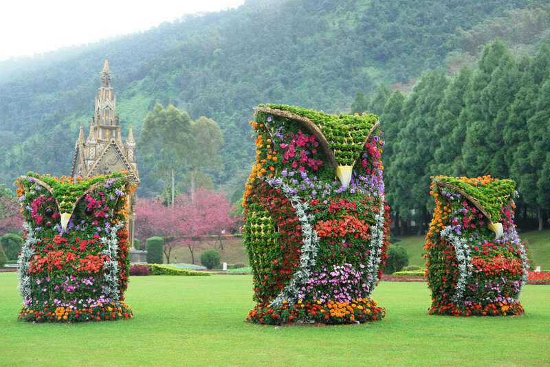 Floral owl sculptures in a park