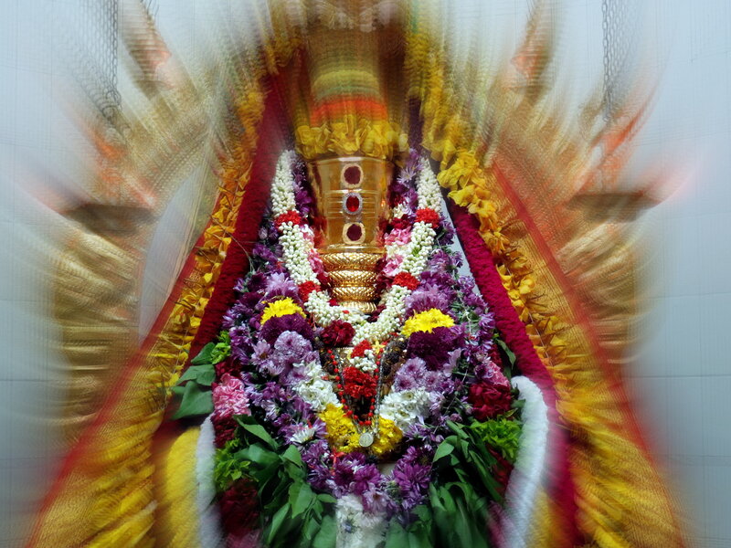 Flower-adorned Deity Statue