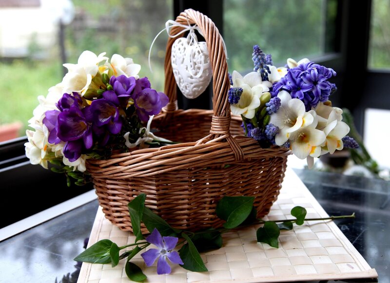 Flower basket with purple and white blooms
