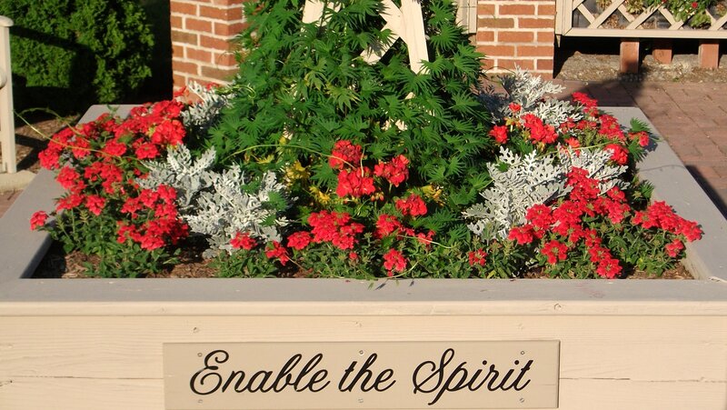 Flower bed with inspirational sign