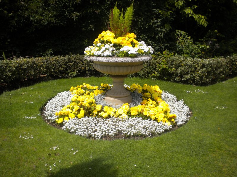 Flower bed with stone urn