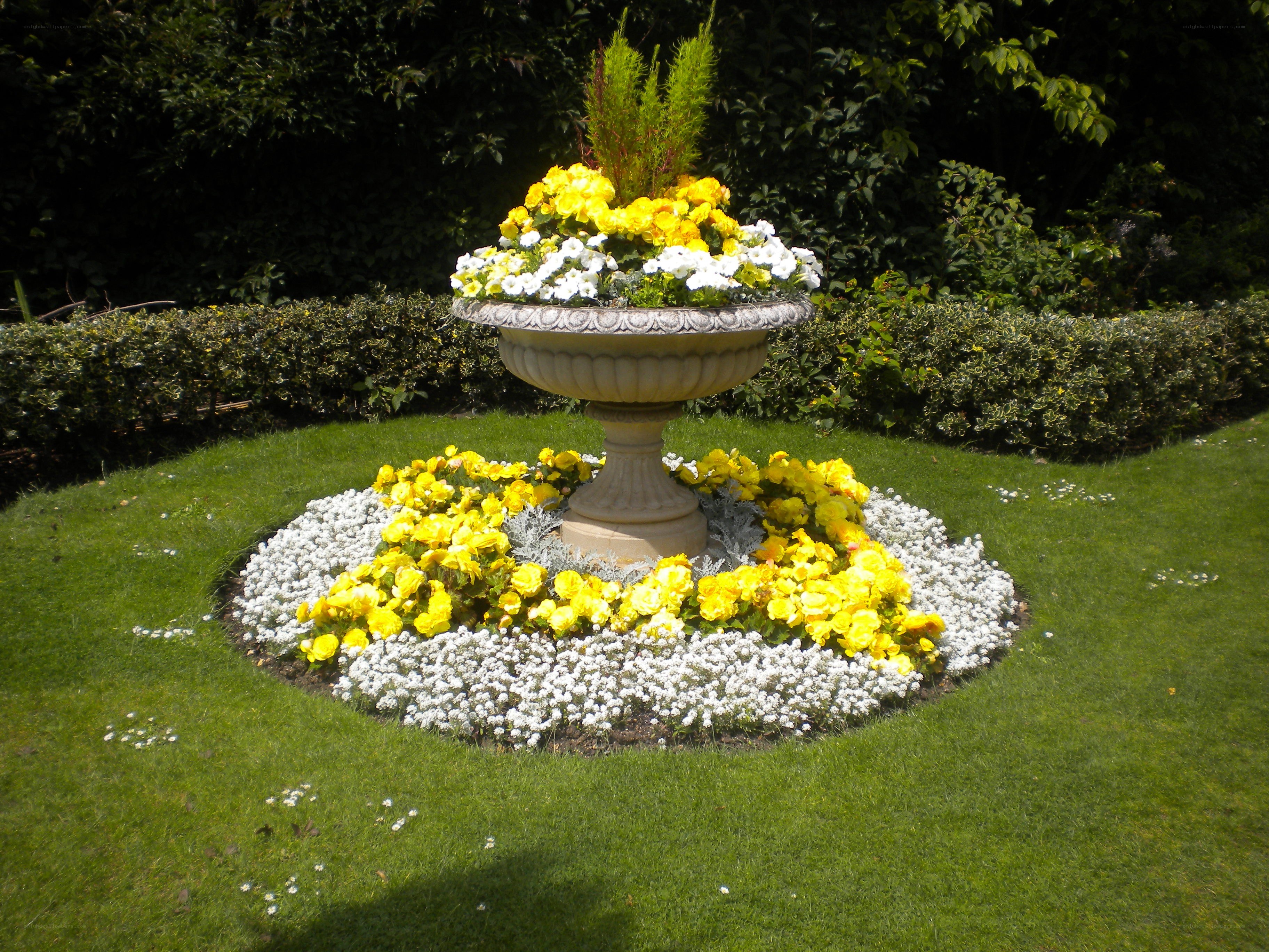Flower bed with stone urn