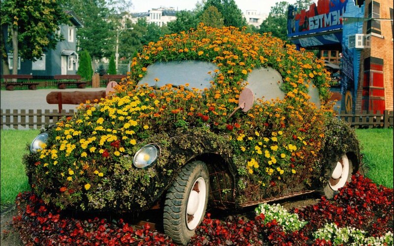 Flower-covered car sculpture