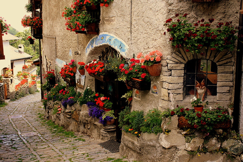 Flower-decked alley in a stone village