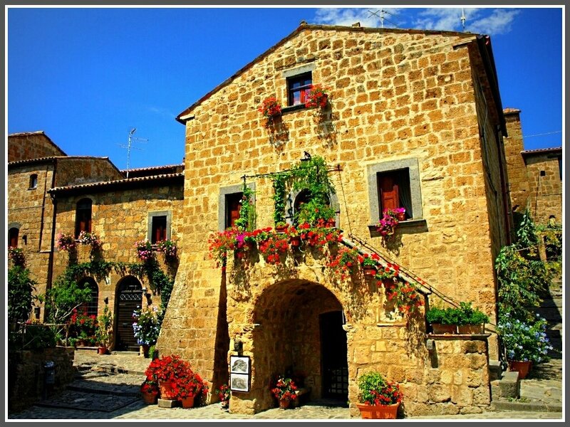 Flower-decked stone building in Italy