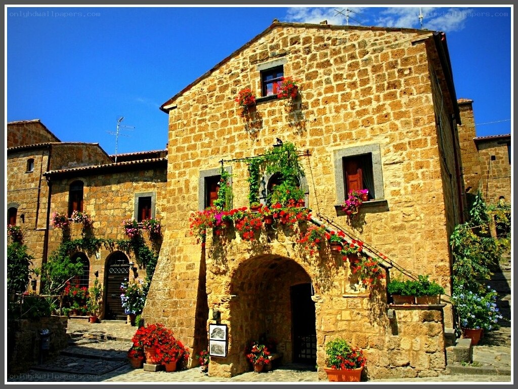 Flower-decked stone building in Italy