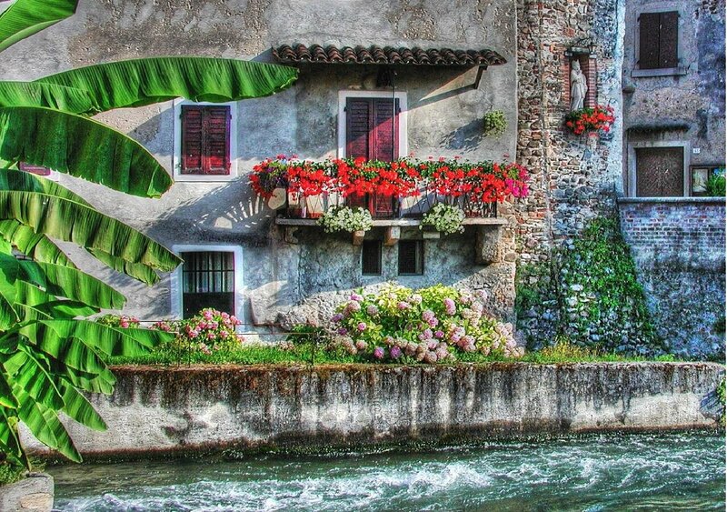 Flower-filled balcony by the river