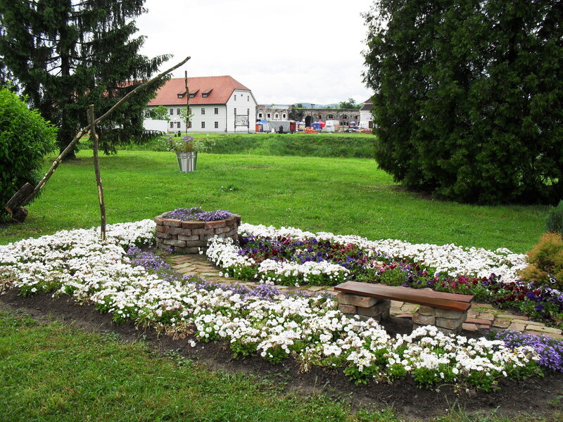 Flower garden with bench and building