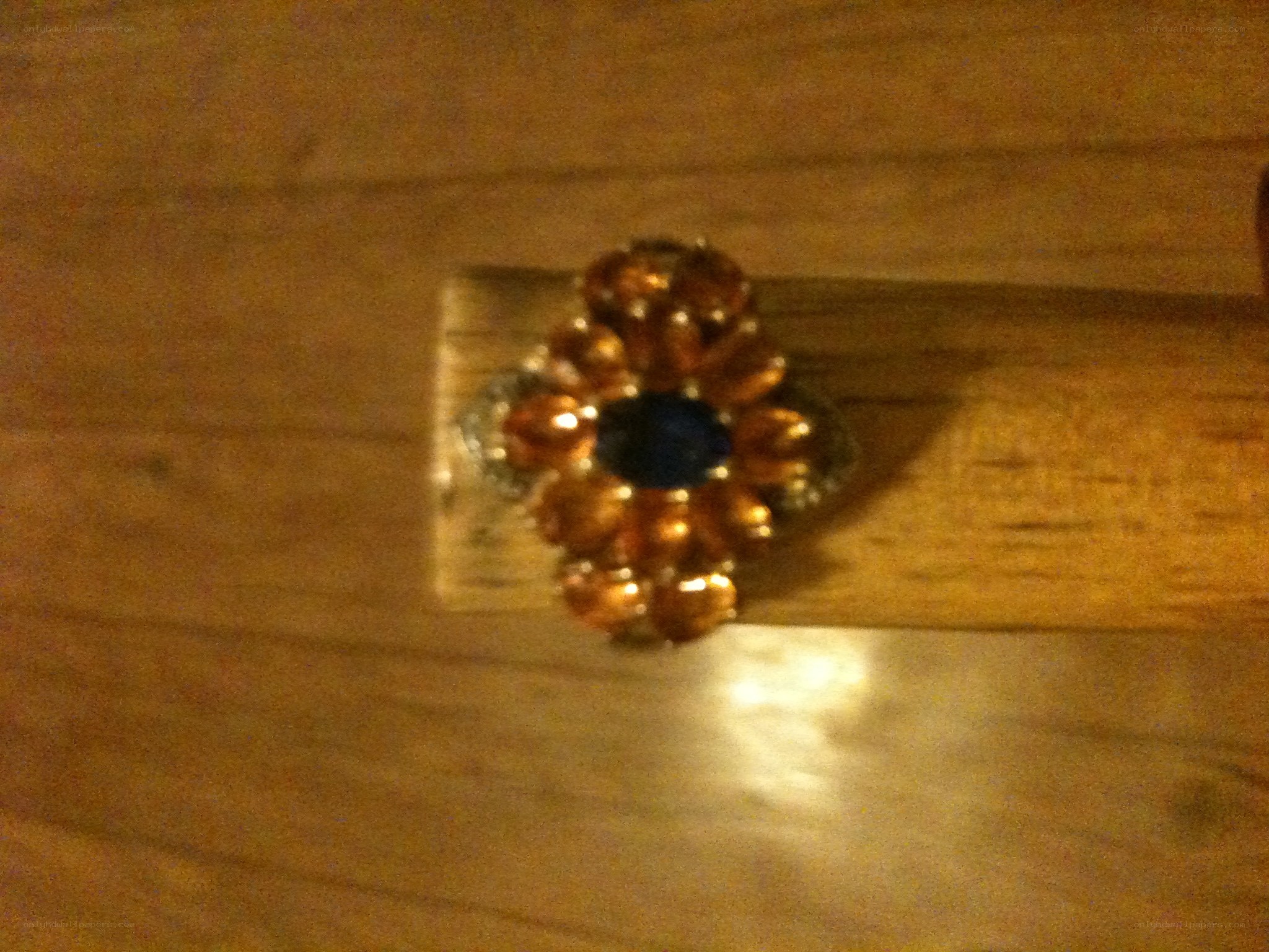 flower-shaped ring on wood