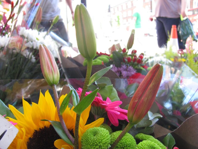 Flower shop display with lilies and sunflowers