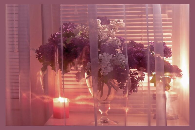 flowers and candle by window