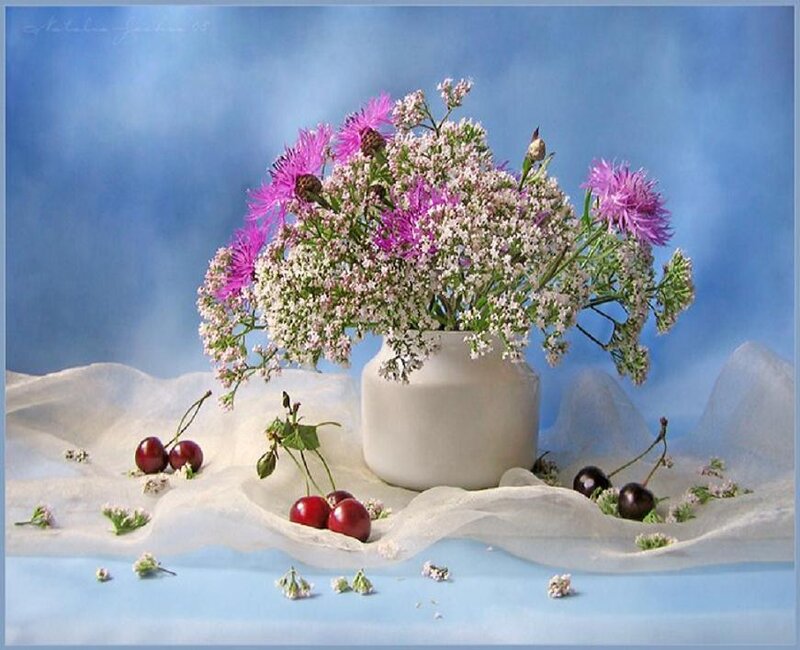 Flowers and cherries in a vase