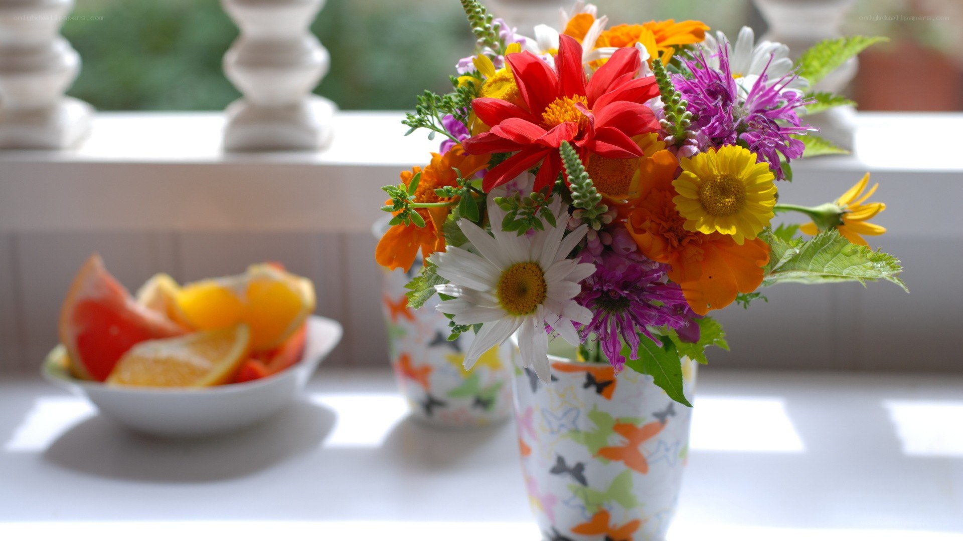 Flowers and fruit on a windowsill