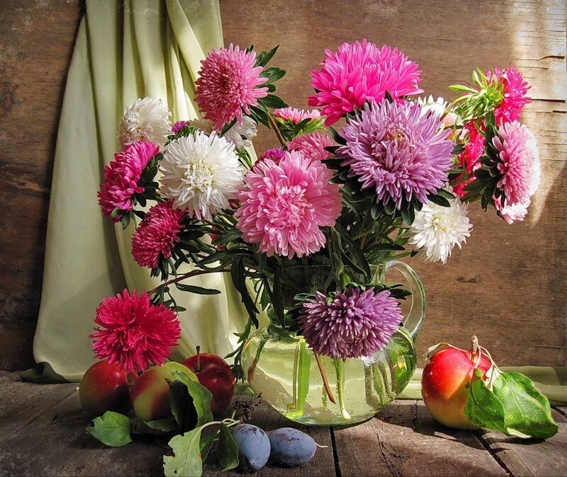 Flowers and fruit on wood