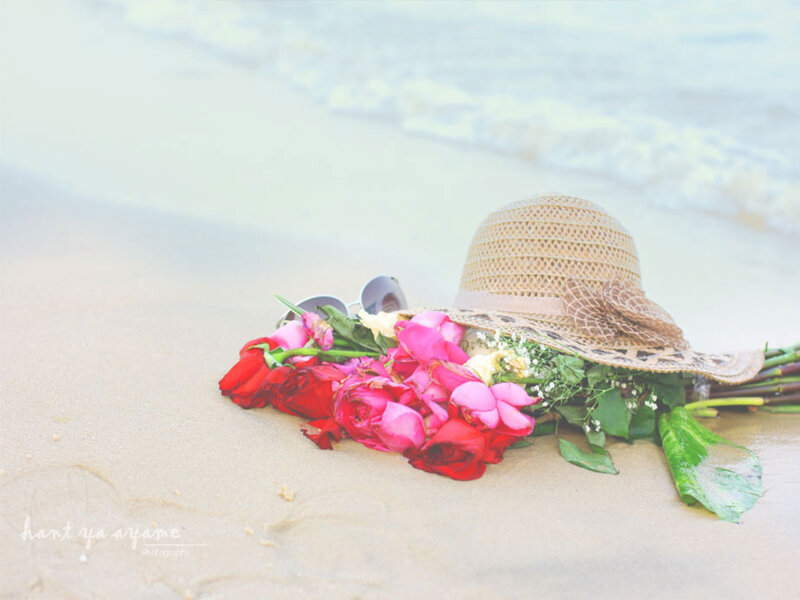 Flowers and Hat on Beach