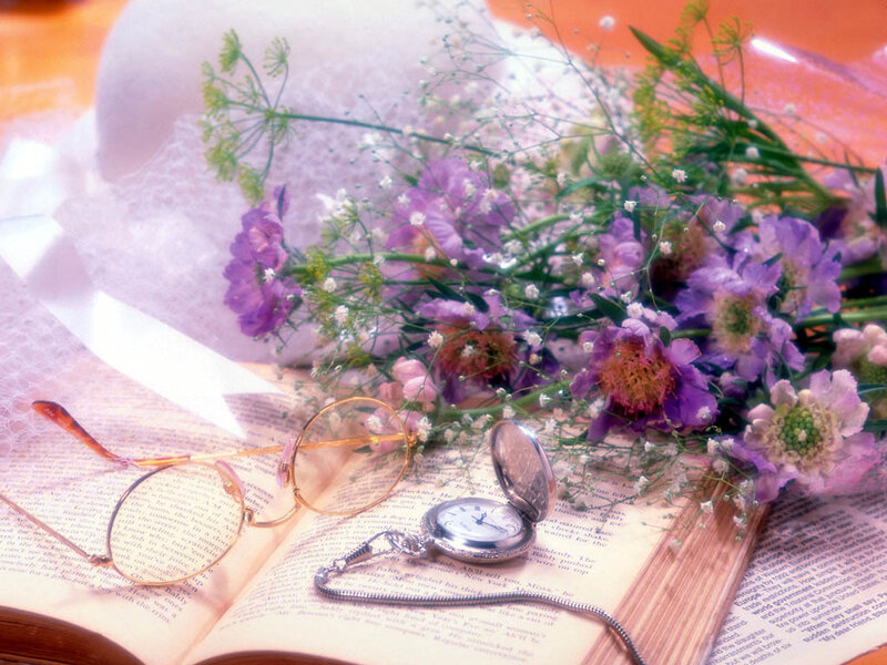 Flowers and pocket watch on book