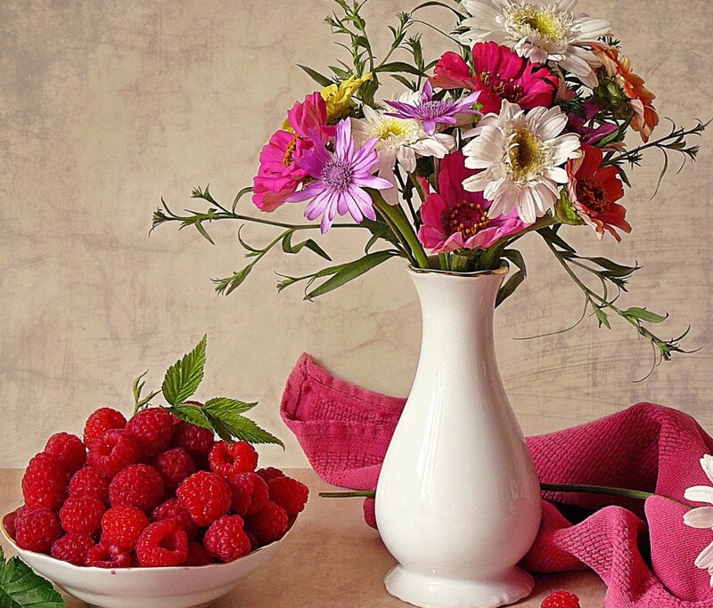 Flowers and raspberries still life