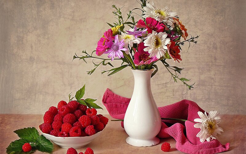 Flowers and raspberries still life