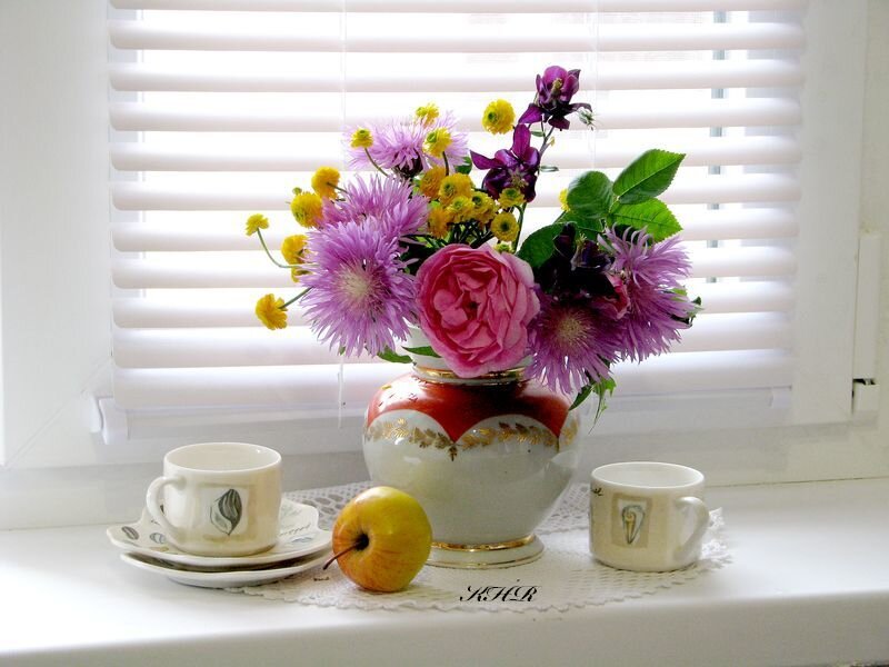 Flowers and tea on a windowsill