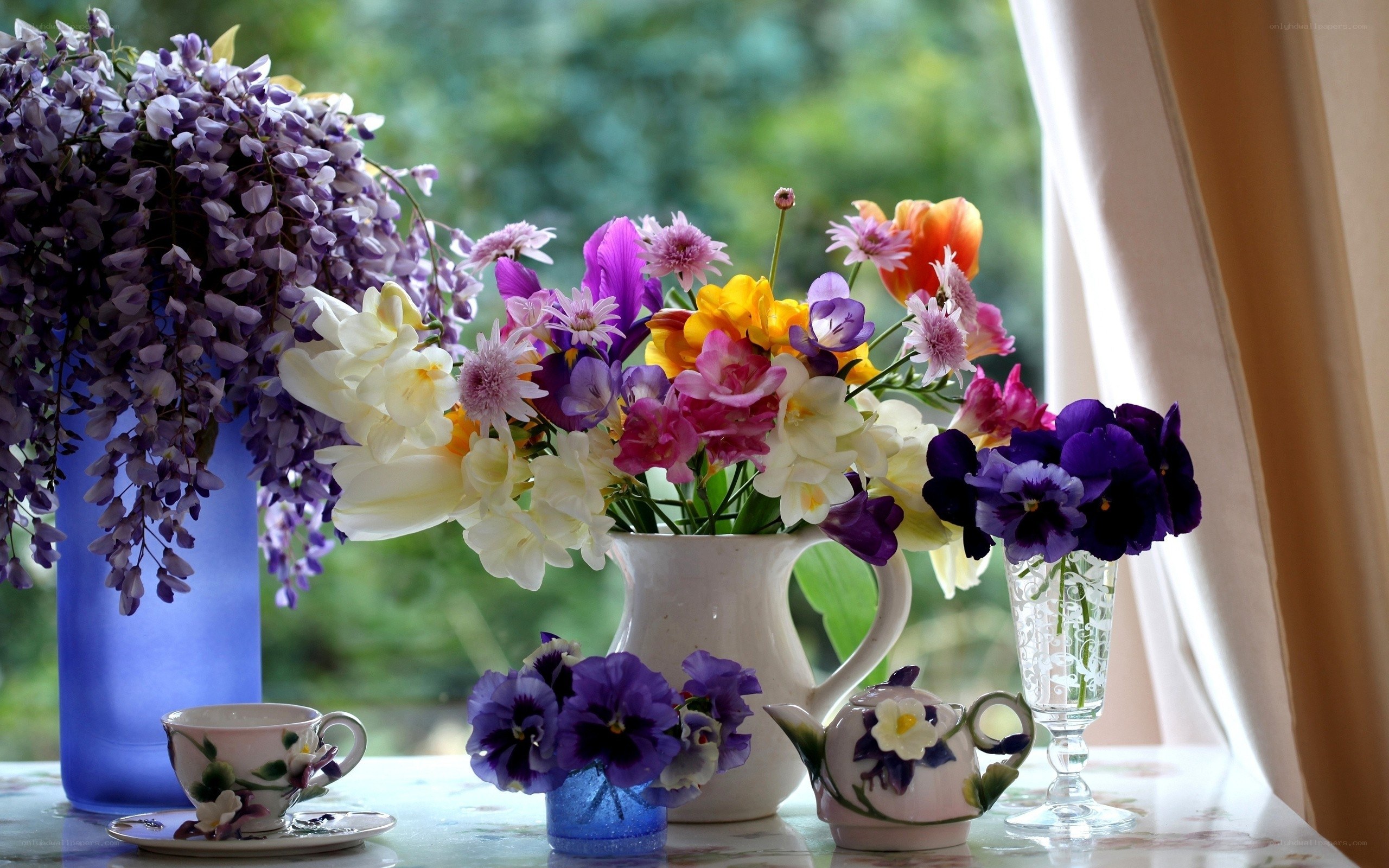 Flowers and tea on a windowsill