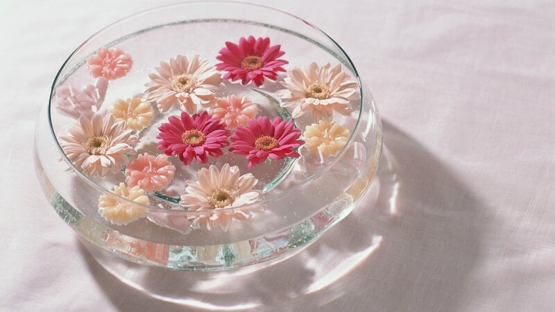 flowers floating in a glass bowl