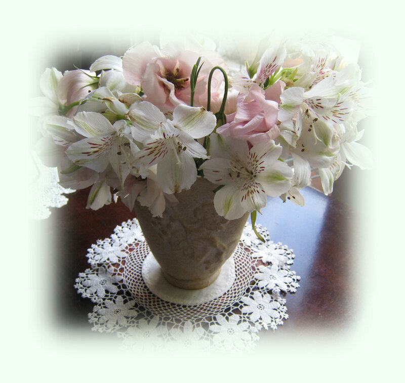 Flowers in a vase on lace