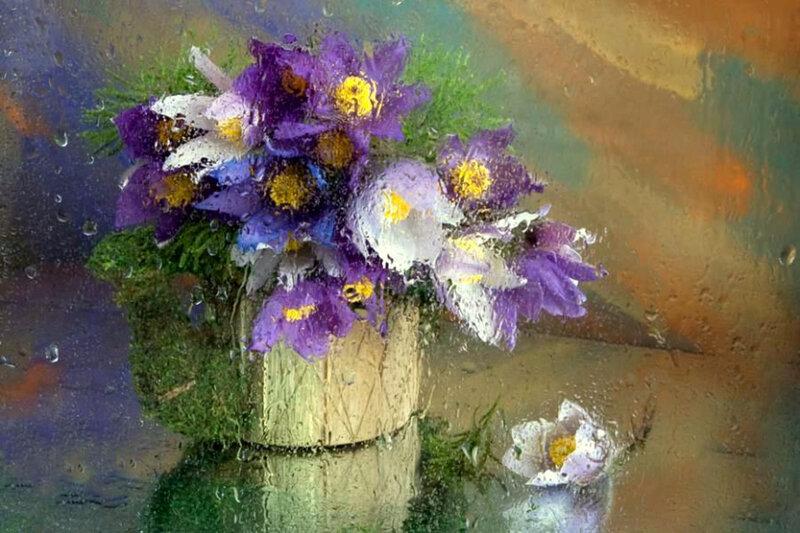 flowers in a vase on rainy glass