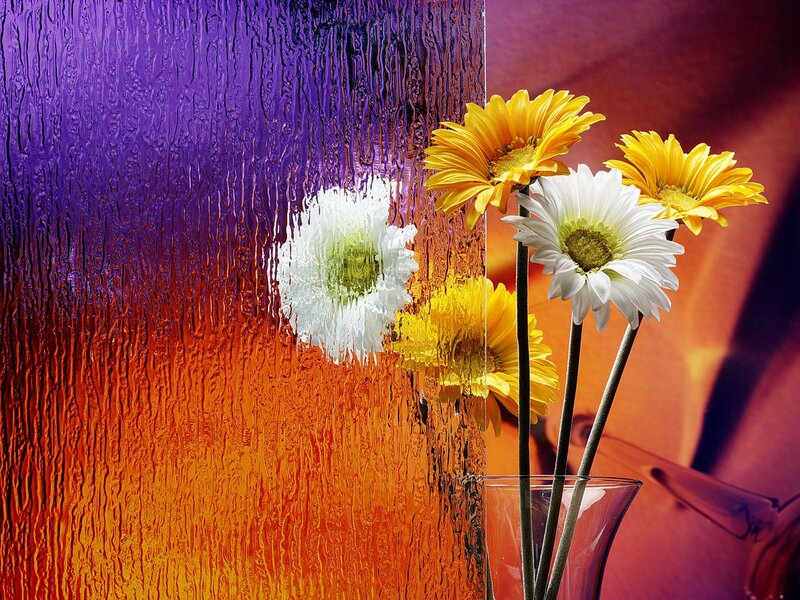 Flowers in a vase with colorful glass