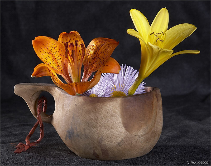 Flowers in a wooden cup